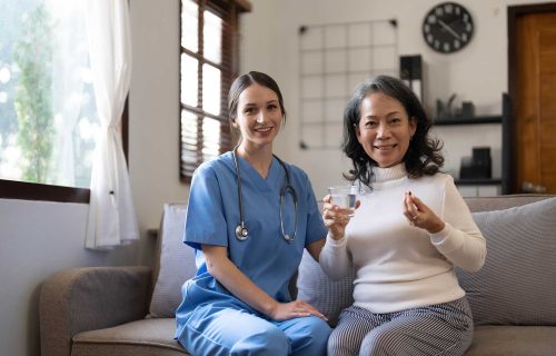 asian-nurse-showing-health-checkup-report-to-grand-HZ356JB.jpg
