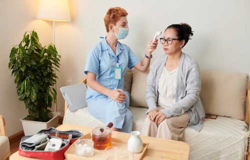 nurse-examining-patient-at-home-HYRZQRT.jpg